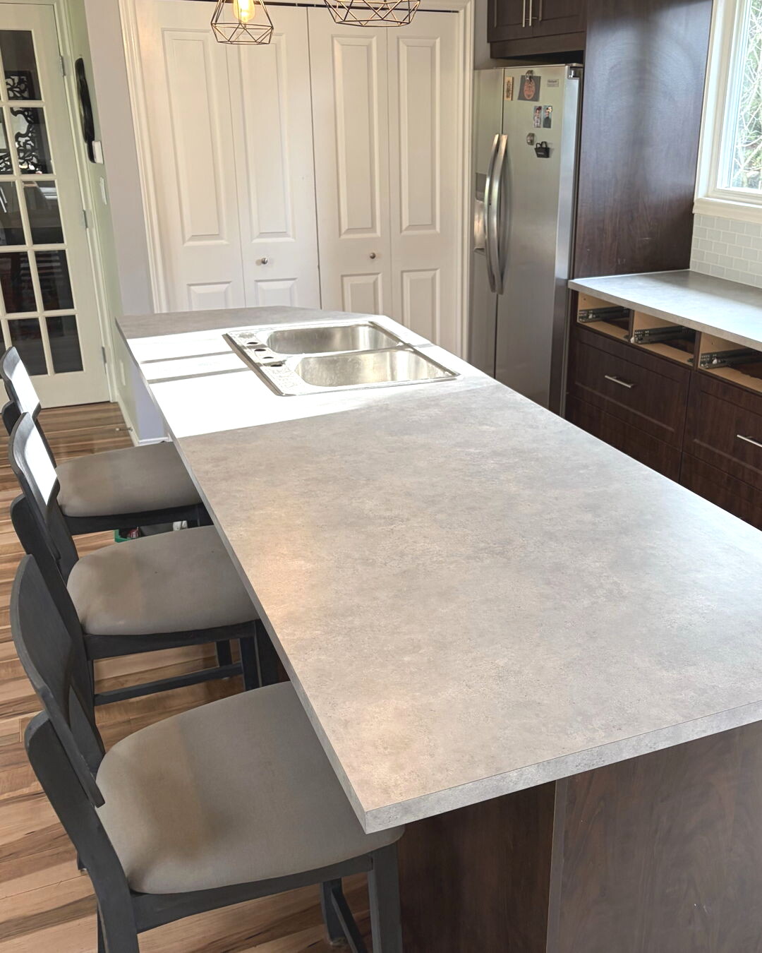 Home kitchen with a spacious stone-look laminate island countertop