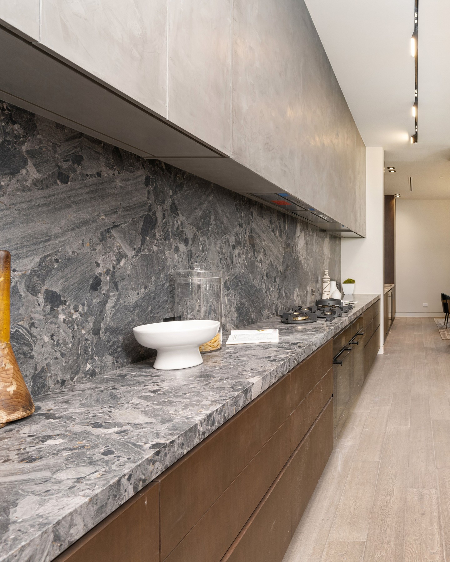 Contemporary kitchen with dramatic grey natural stone countertops and backsplash