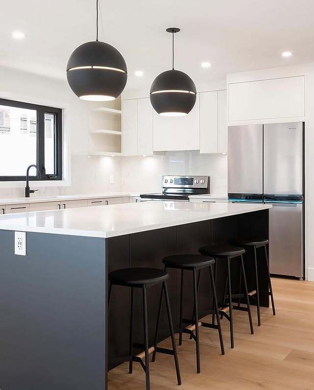 Bright modern kitchen with white quartz countertops and island