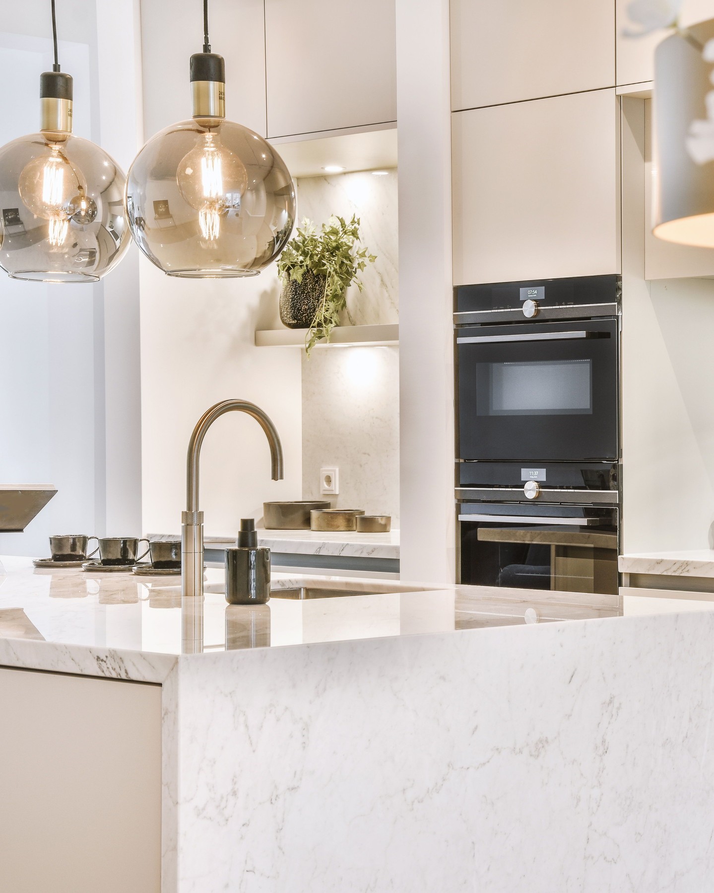 Elegant modern kitchen with a bright quartz waterfall island